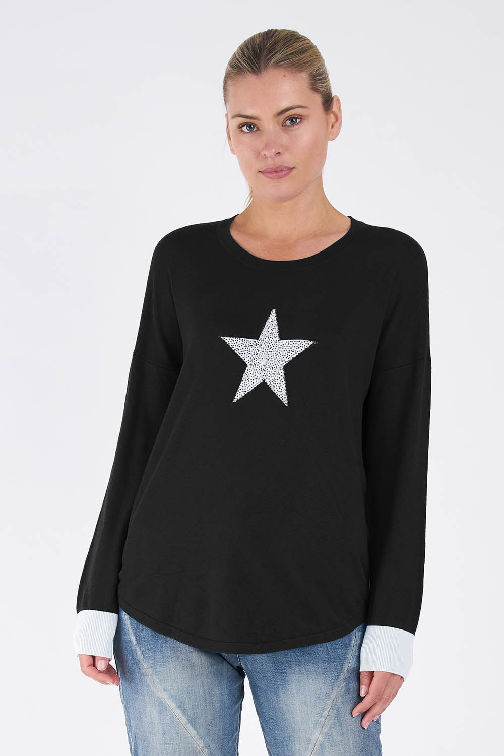 A model wearing the Sophie Knit Jumper in colour Blackstar (Black), from the front, cropped image