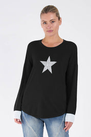 A model wearing the Sophie Knit Jumper in colour Blackstar (Black), from the front, cropped image