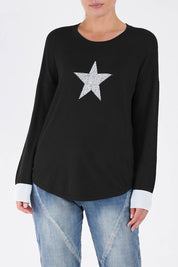 A model wearing the Sophie Knit Jumper in colour Blackstar (Black), from the front, cropped image