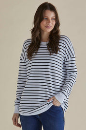 A model wearing the Sophie Knit Jumper in colour Blkstripe (White), from the front, cropped image