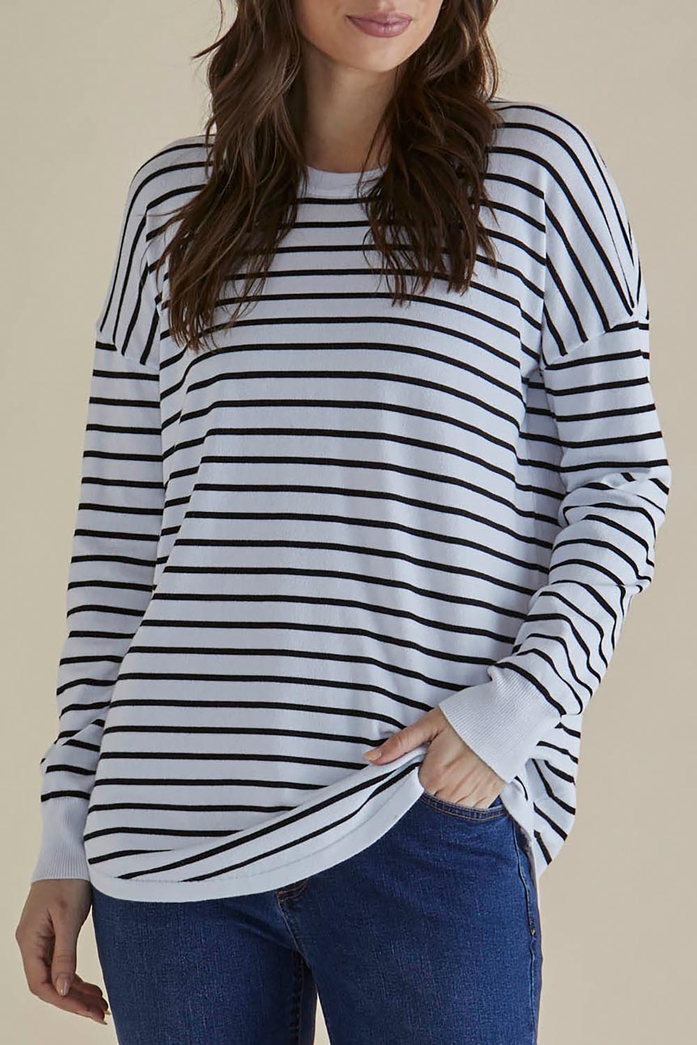 A model wearing the Sophie Knit Jumper in colour Blkstripe (White), from the front, cropped image