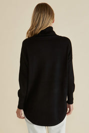 A model wearing the Fleur Roll Neck Jumper in colour Black (Black), from the back