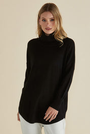 A model wearing the Fleur Roll Neck Jumper in colour Black (Black), from the front, cropped image