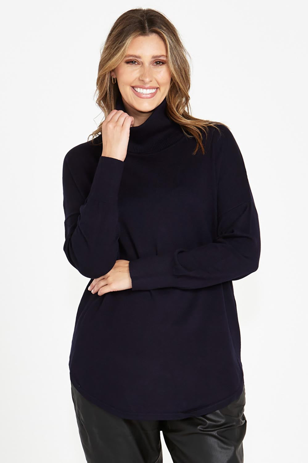 A model wearing the Fleur Roll Neck Jumper in colour Darkblue (Blue), from the front, cropped image