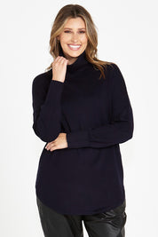 A model wearing the Fleur Roll Neck Jumper in colour Darkblue (Blue), from the front, cropped image