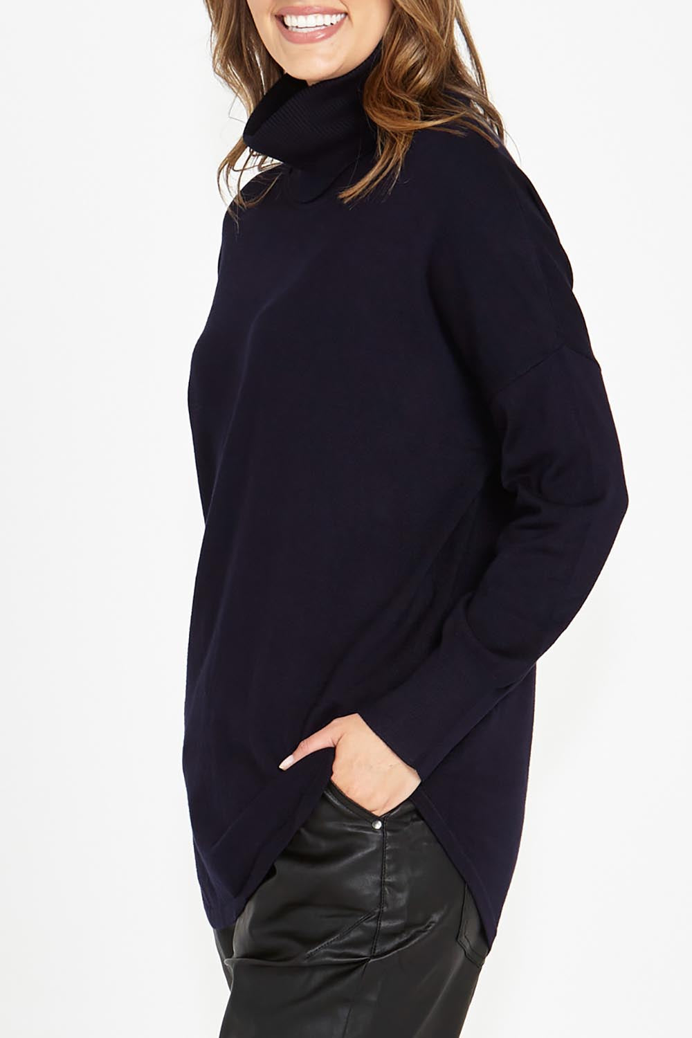 A model wearing the Fleur Roll Neck Jumper in colour Darkblue (Blue), from the front, cropped image