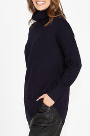 A model wearing the Fleur Roll Neck Jumper in colour Darkblue (Blue), from the front, cropped image