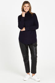 A model wearing the Fleur Roll Neck Jumper in colour Darkblue (Blue), from the front, showing the whole outfit