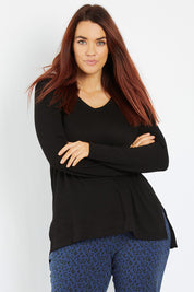 Model Laura wearing size 12 of the Zara Waffle Top in colour Black (Black), from the front, cropped image