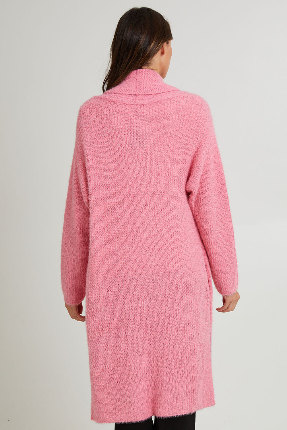 Model Madeline wearing size S of the Mia Cardigan in colour Floss (Pink), from the back