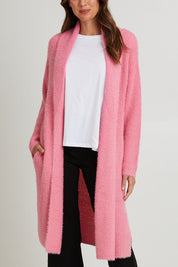 Model Madeline wearing size S of the Mia Cardigan in colour Floss (Pink), from the front, cropped image