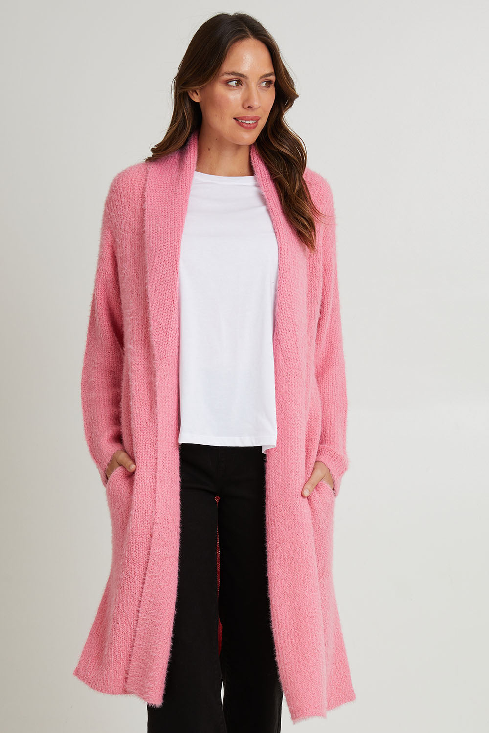 Model Madeline wearing size S of the Mia Cardigan in colour Floss (Pink), from the front, cropped image