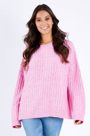 Model Vitoria wearing size S of the Kayla Knit Jumper in colour Floss (Pink), from the front, cropped image