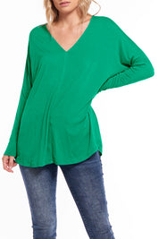 A model wearing the Oslo Top in colour Lime (Green), from the front, cropped image