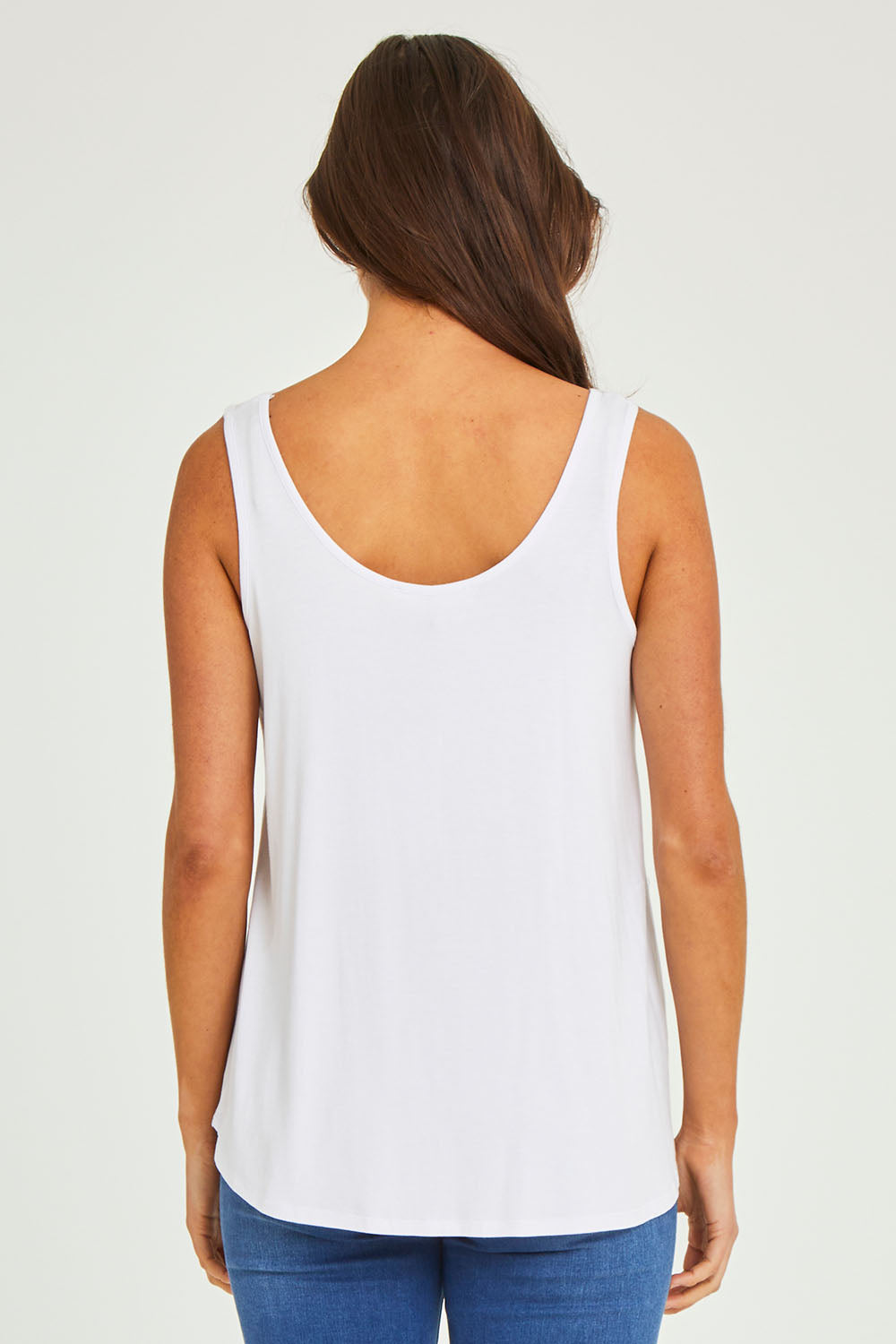 Model Elhana wearing size 10 of the Sirena Reversible Tank in colour White (White), from the back