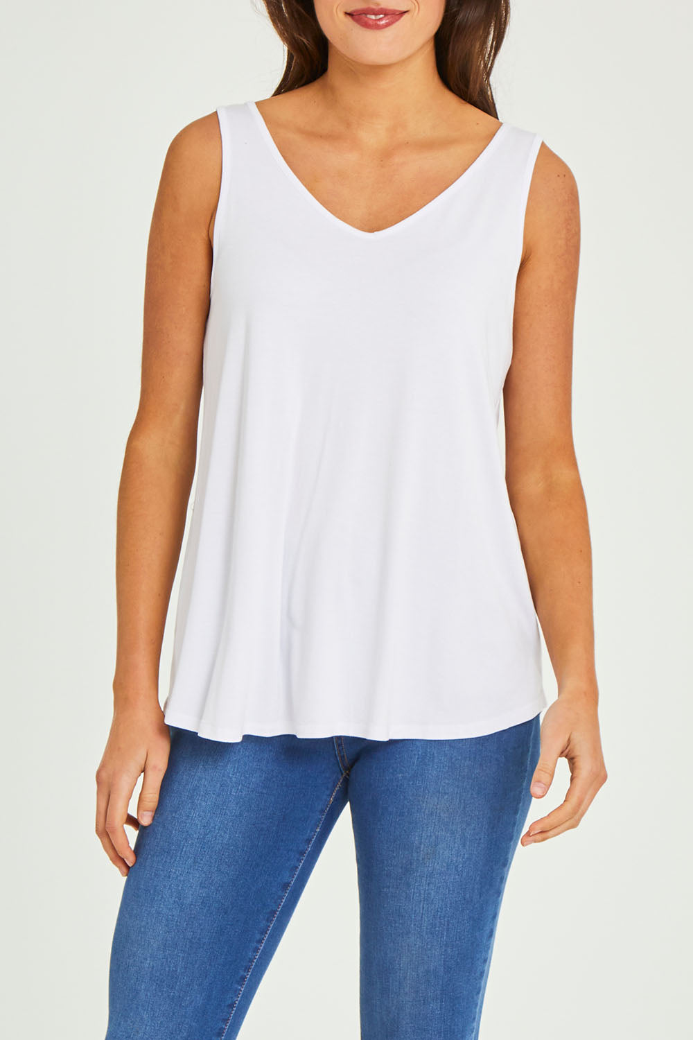 Model Elhana wearing size 10 of the Sirena Reversible Tank in colour White (White), from the front, cropped image