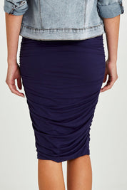 Model Madeline wearing size 10 of the Nadia Skirt in colour Navy (Blue), from the back