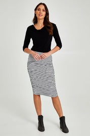 Model Madeline wearing size 10 of the Nadia Skirt in colour Noirstripe (Black), from the front, showing the whole outfit