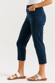 A model wearing the Crop Bengaline Pant in colour Navy (Blue), from the front, cropped image