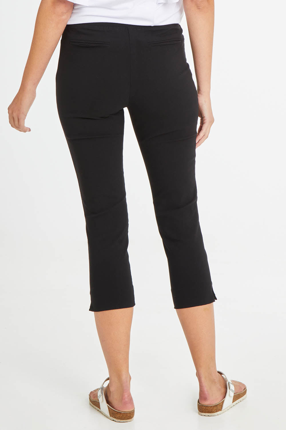 Model Madeline wearing size 10 of the Crop Bengaline Pant in colour Black (Black), from the back