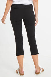 Model Madeline wearing size 10 of the Crop Bengaline Pant in colour Black (Black), from the back