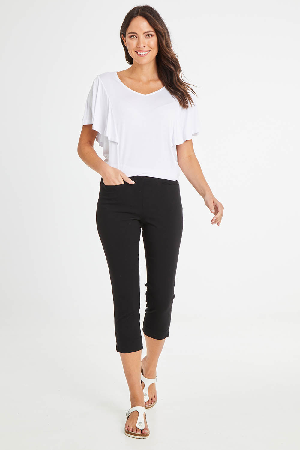 Model Madeline wearing size 10 of the Crop Bengaline Pant in colour Black (Black), from the front, showing the whole outfit