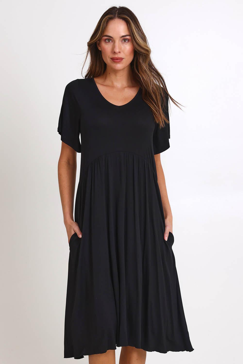 Model Madelinec wearing size 10 of the Donna Dress - Black in colour Black, from the front