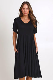 Model Madelinec wearing size 10 of the Donna Dress - Black in colour Black, from the front