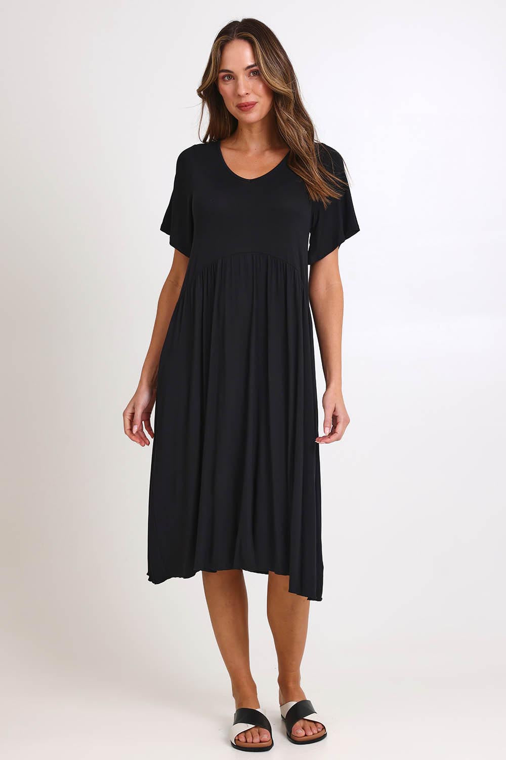 Model Madelinec wearing size 10 of the Donna Dress - Black in colour Black, from the front
