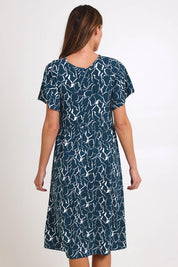 Model Madelinec wearing size 10 of the Donna Dress – Teal in colour Teal, from the back