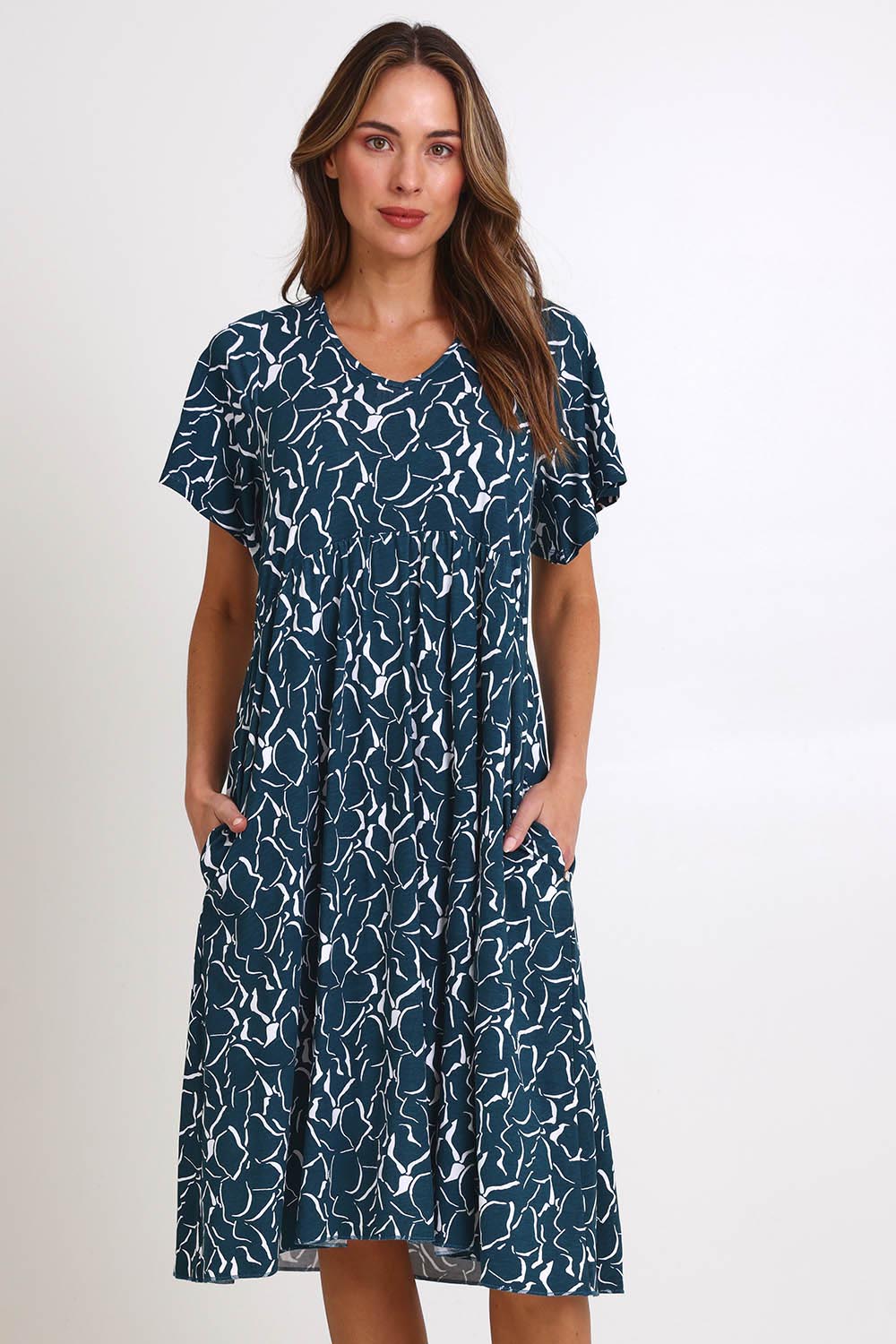 Model Madelinec wearing size 10 of the Donna Dress – Teal in colour Teal, from the front