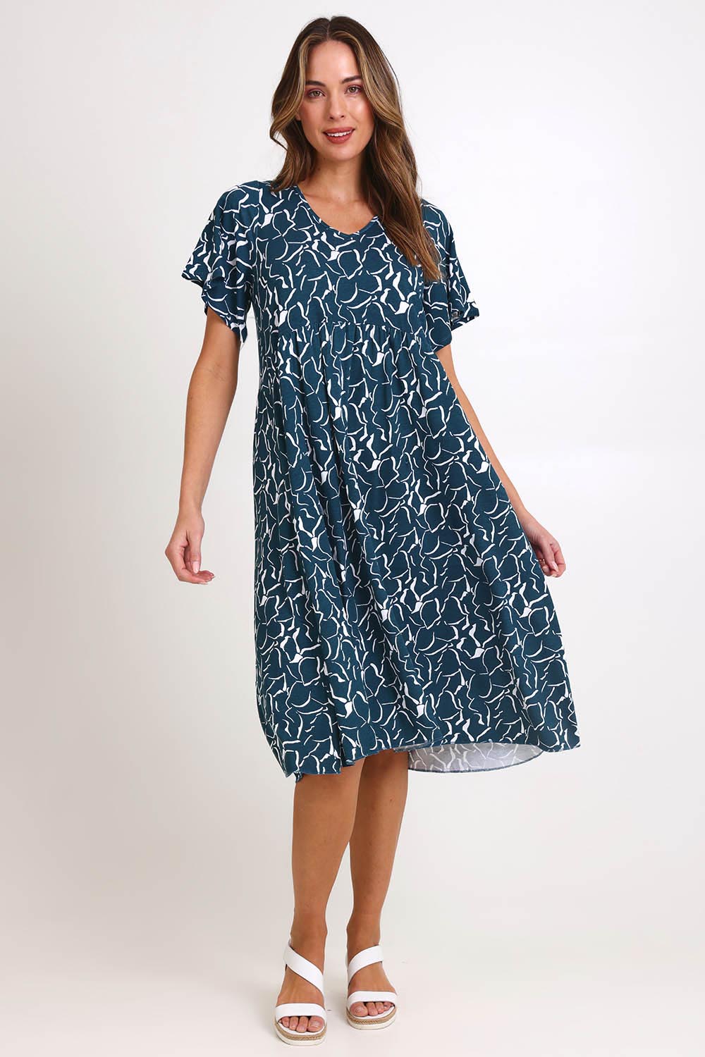 Model Madelinec wearing size 10 of the Donna Dress – Teal in colour Teal, from the front
