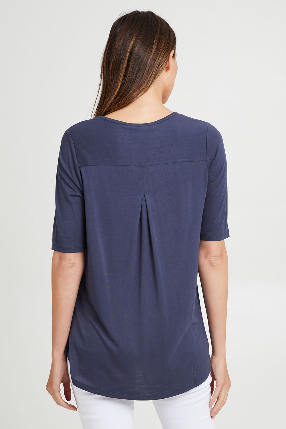Model Madeline wearing size 10 of the Maya Tee in colour Dustyblue (Blue), from the back