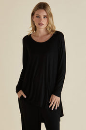 A model wearing the Cairo Tunic Bamboo Top in colour Black (Black), from the front, cropped image