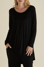 A model wearing the Cairo Tunic Bamboo Top in colour Black (Black), from the front, cropped image