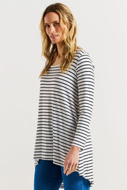 A model wearing the Cairo Tunic Bamboo Top in colour Monostripe (White), from the front, cropped image