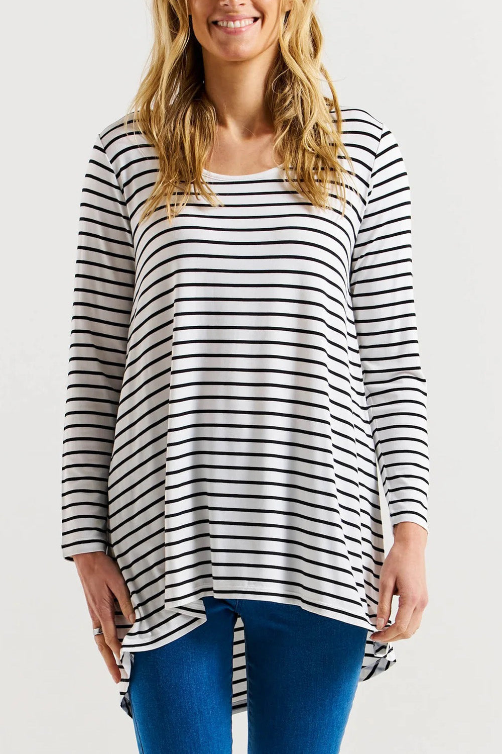 A model wearing the Cairo Tunic Bamboo Top in colour Monostripe (White), from the front, cropped image