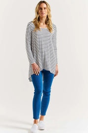 A model wearing the Cairo Tunic Bamboo Top in colour Monostripe (White), from the front, showing the whole outfit