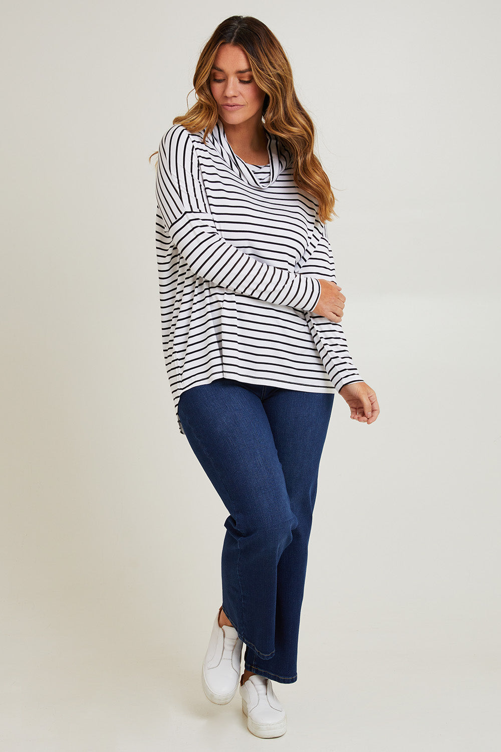 Model Laura wearing size 14 of the Cowl Bamboo Top in colour Monostripe (White), from the front, showing the whole outfit