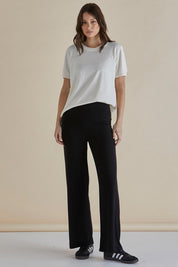 A model wearing the Houston Relaxed Pant in colour Black (Black), from the front, showing the whole outfit