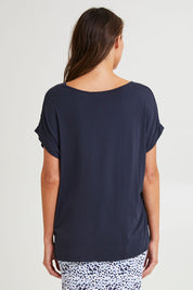 Model Madeline wearing size 10 of the Fallon Bamboo Top in colour Petrol (Blue), from the back