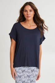 Model Madeline wearing size 10 of the Fallon Bamboo Top in colour Petrol (Blue), from the front, cropped image