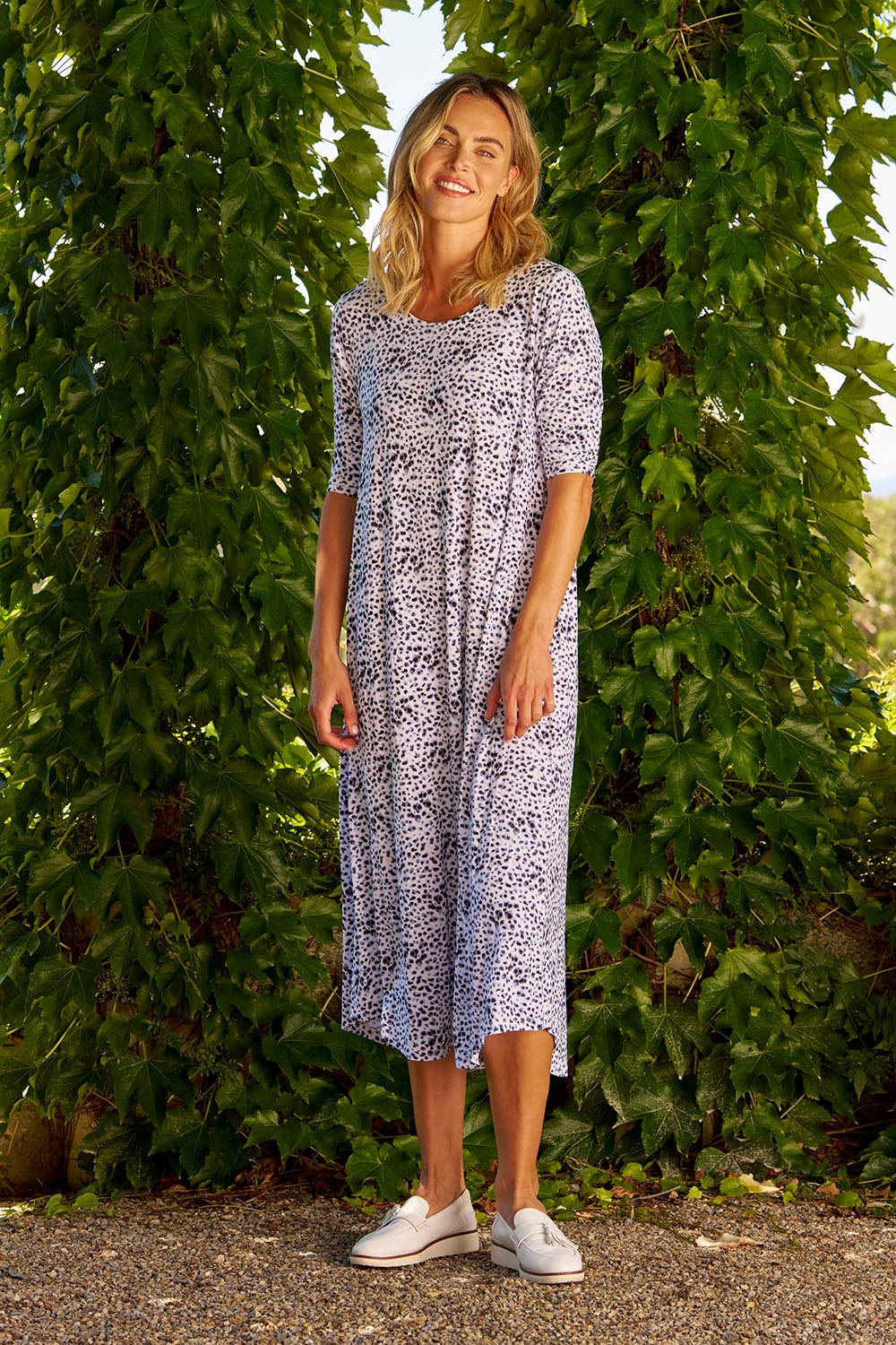 A model wearing the Marlene Bamboo Dress in colour Snowleop (White), from the front, showing the whole outfit