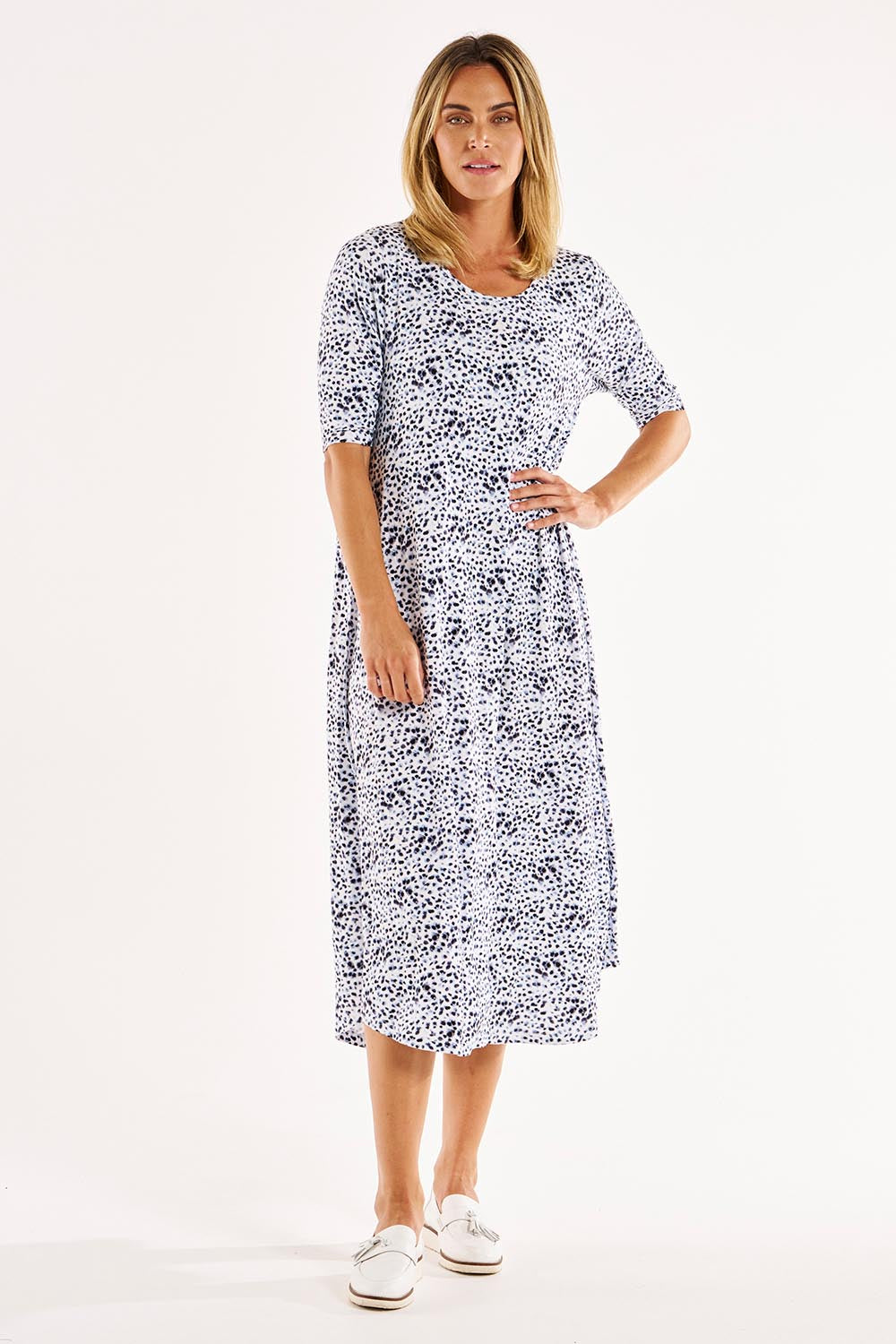 A model wearing the Marlene Bamboo Dress in colour Snowleop (White), from the front, showing the whole outfit