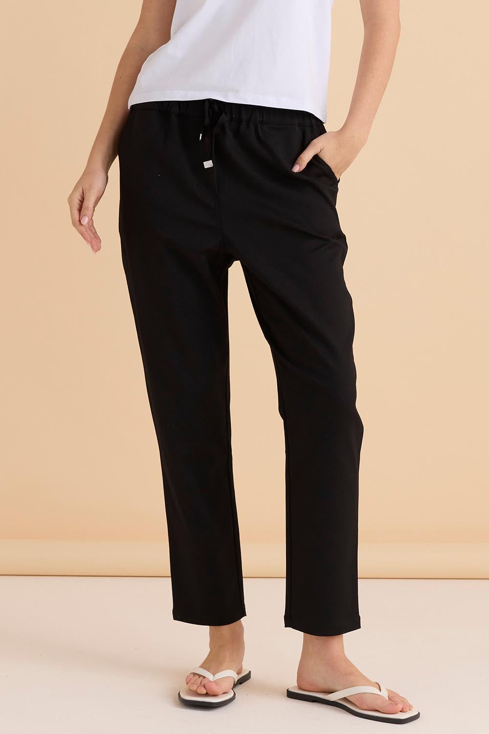 A model wearing the Kenzie Cotton Blend Jogger in colour Black (Black), from the front, cropped image