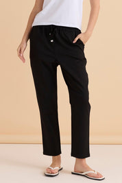 A model wearing the Kenzie Cotton Blend Jogger in colour Black (Black), from the front, cropped image