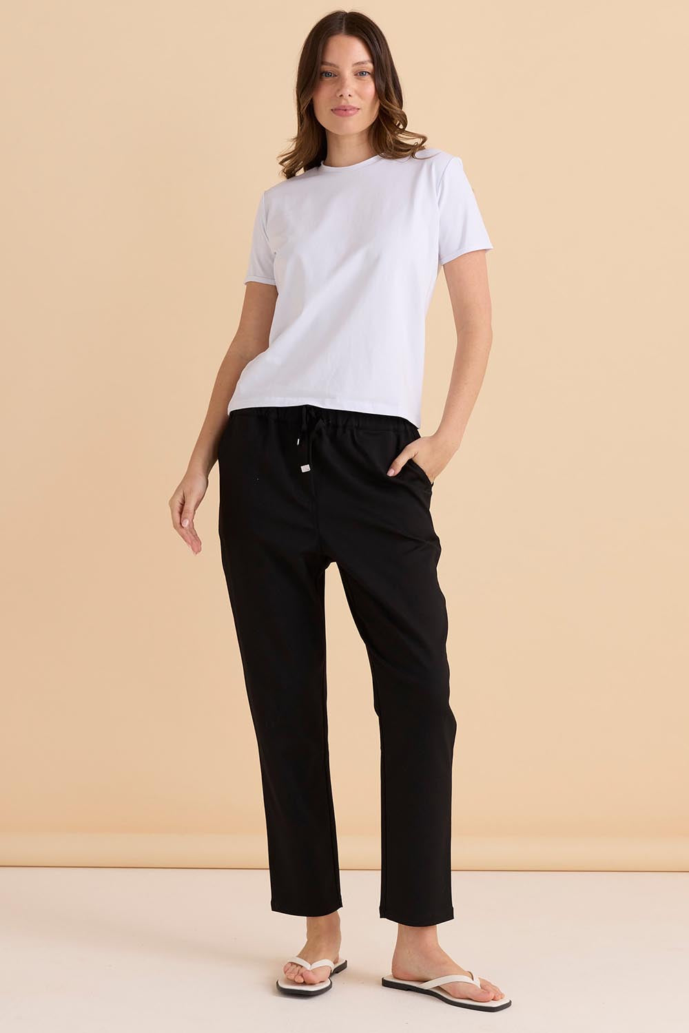 A model wearing the Kenzie Cotton Blend Jogger in colour Black (Black), from the front, showing the whole outfit