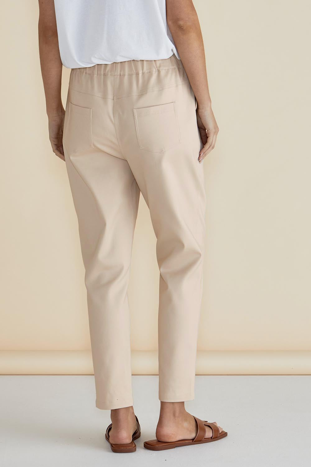 A model wearing the Kenzie Cotton Blend Jogger in colour Cream, from the back