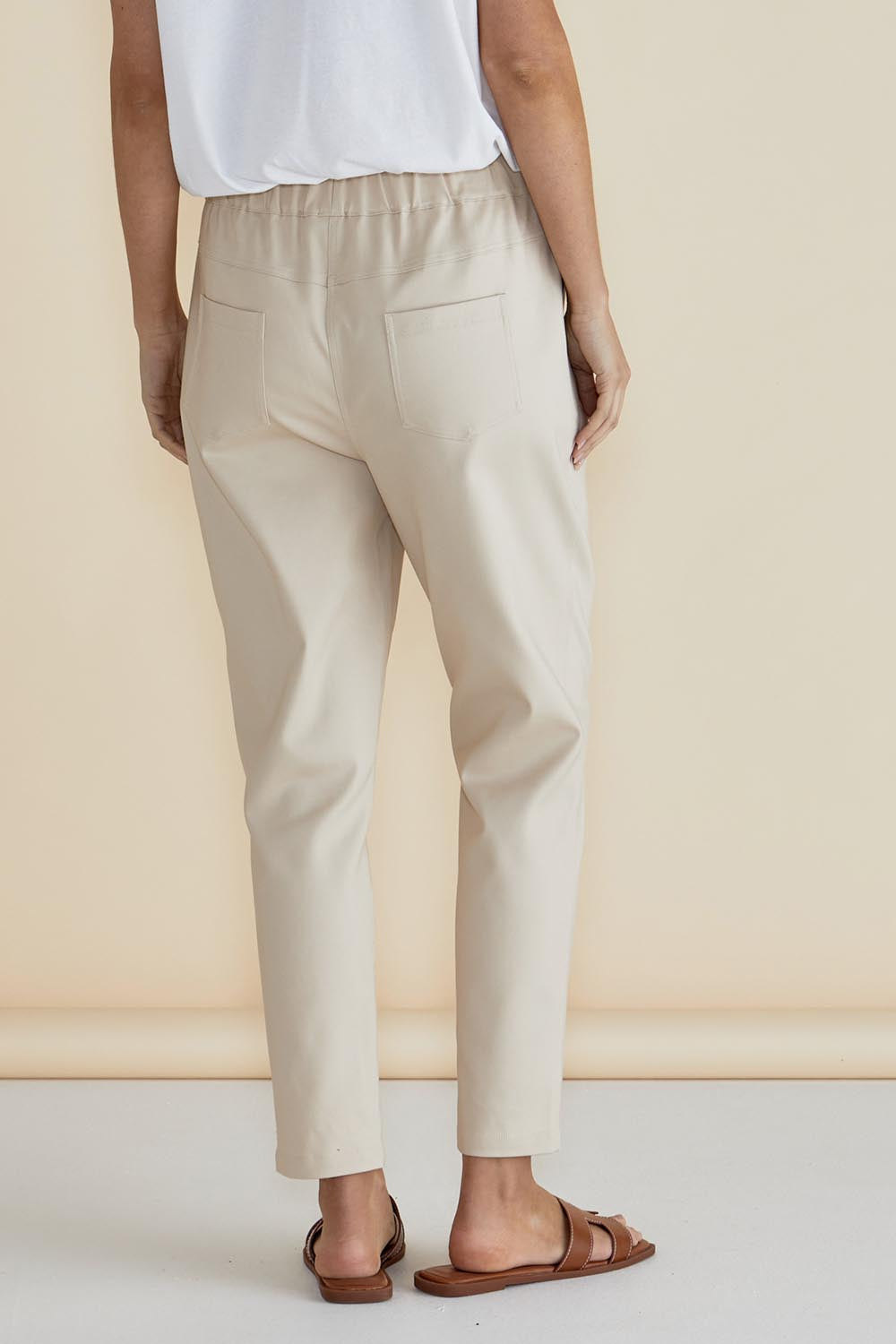 A model wearing the Kenzie Cotton Blend Jogger in colour Cream, from the back