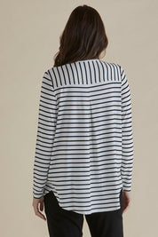 A model wearing the Yasmin Bamboo Long Sleeve Top in colour Blkstripe (White), from the back